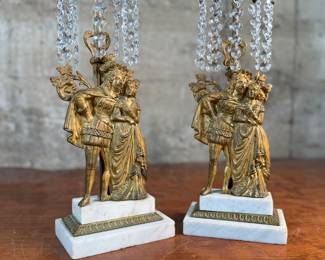 This lot features a pair of high quality Victorian polished brass candelabras with prisms and marble bases. Each one measures, 15.5” H x 5.5” W x 3.5” D.