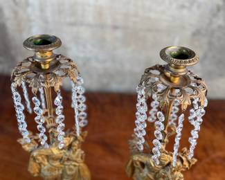 This lot features a pair of high quality Victorian polished brass candelabras with prisms and marble bases. Each one measures, 15.5” H x 5.5” W x 3.5” D.