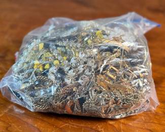 This lot features a large bag of costume jewelry that weighs 4lbs.