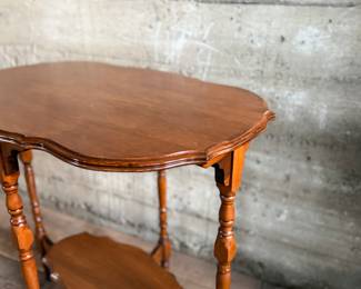 This lot features a solid wood oval shaped parlor table that measures, 29” H x 30” W x 20” D.