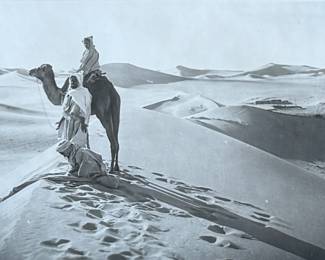 “Arab Desert Scenes”, three professionally framed silver gelatin prints by listed photographers, Rudolf Franz Lehnert & Ernst Heinrich Landrock. Measures in frame, 10” H x 30” W. Rudolf Franz Lehnert (1878-1948) and Ernst Heinrich Landrock (1880-1957), a renowned photographic team of the early 20th century, known for their Orientalist images, often featuring desert scenes with camels and local inhabitants, distributed as original prints, photogravures, and postcards.