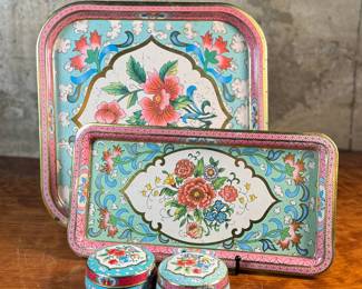 This lot features a collection of four (4) pieces of Daher Decorative Ware including two trays & two tin boxes. The largest tray measures, 13.75” H x 13.75” W. Daher’s most recognizable tins are decorated with detailed floral and geometric designs, rich in color, and often including metallic inks and raised or embossed relief. In addition to tin boxes, Daher also produced trays, plates, plaques, and other assorted tin ware for practical and decorative use.