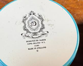 This lot features a collection of four (4) pieces of Daher Decorative Ware including two trays & two tin boxes. The largest tray measures, 13.75” H x 13.75” W. Daher’s most recognizable tins are decorated with detailed floral and geometric designs, rich in color, and often including metallic inks and raised or embossed relief. In addition to tin boxes, Daher also produced trays, plates, plaques, and other assorted tin ware for practical and decorative use.