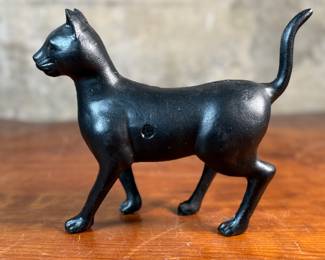 This lot features a vintage cast iron “cat” bank that measures, 7.5” H x 9” W x 3” D.