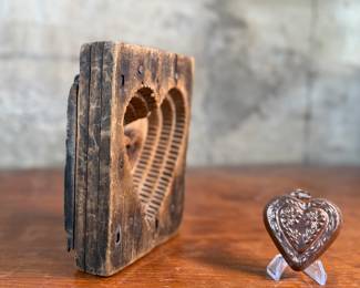 This lot features an antique wooden heart mold and a copper heart!