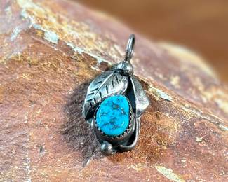This lot features a sterling silver pendant with a turquoise stone, signed by listed artist, David F. Garcia. This pendant measures, 1.25” H and has a total approx. weight of 3.50 grams.