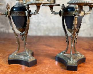 This lot features a pair of antique French gilt bronze and black marble candelabras in very good condition. Each one measures, 12” H x 8” W x 8” D.