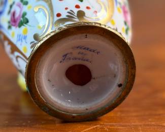 This lot features a collection of inkwells and accessories. One appears to be handmade out of wood and signed underneath by John R Craighead.