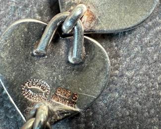 This lot features an iconic sterling silver hearts bracelet, a delightful classic design by Danish modernist Karl-Gustav Hansen for Hans Hansen, made in Denmark circa 1950s. Karl Gustav Hansen was the son Hans Hansen and later merged with the Georg Jensen company. This bracelet has the Hans Hansen designed screw-down clasp lock, measures 7” with a total approx. weight of 28.80 grams. Maker mark present as shown in photos.