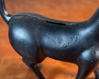 This lot features a vintage cast iron “cat” bank that measures, 7.5” H x 9” W x 3” D.