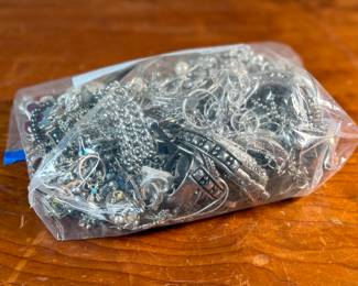 This lot features a large bag of costume jewelry that weighs 4lbs.