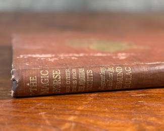 This lot features a rare edition of, "The Magic Horse and Other Stories from The Arabian Nights", retold by author Laurence Housman. This edition features drawings and illustrations by the notable artist, Edmund Dulac.