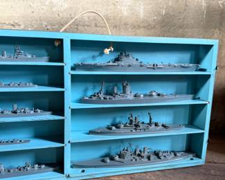 This lot features a complete set of WWII U.S. Navy recognition ship models in their original, self-contained wooden display case. These sets were manufactured by H.A. Framburg & Co. for the U.S. Navy Bureau of Aeronautics to help personnel identify friendly and enemy vessels during the war. This set measures (closed), 18.5” H x 36.5” W x 6.75” D. These models are generally considered 1/1200 scale, and were used as identification and training aids for the Navy during World War II.