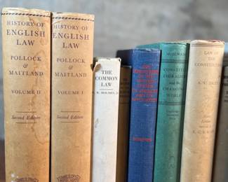 This lot features a collection of antique and vintage books, primarily on various types of law.