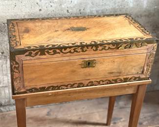 This lot features an incredible 19th century Italian travel desk on a wooden stand. The travel desk is removable and features numerous drawers and compartments inside. This piece measures (on the stand), 26” H x 20” W x 11” D.