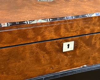 This lot features a 19th century burled walnut writing slope on a lacquered stand. The burled walnut top has a central brass inlaid presentation plaque that is inscribed. This piece measures (on stand), 18” H x 15.5” H x 11” D.