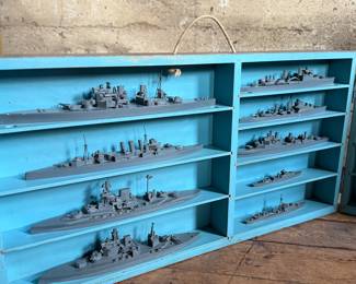 This lot features a complete set of WWII U.S. Navy recognition ship models in their original, self-contained wooden display case. These sets were manufactured by H.A. Framburg & Co. for the U.S. Navy Bureau of Aeronautics to help personnel identify friendly and enemy vessels during the war. This set measures (closed), 18.5” H x 36.5” W x 6.75” D. These models are generally considered 1/1200 scale, and were used as identification and training aids for the Navy during World War II.