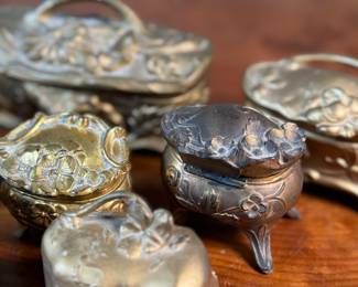 This lot features a large collection of Art Nouveau-style metal jewelry caskets or trinket boxes.