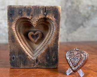 This lot features an antique wooden heart mold and a copper heart!