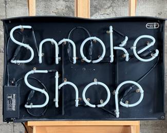 “Smoke Shop”, a vintage neon sign that measures, 20” H x 31” W. This sign appears to be in good overall condition, but is missing the plug to test.