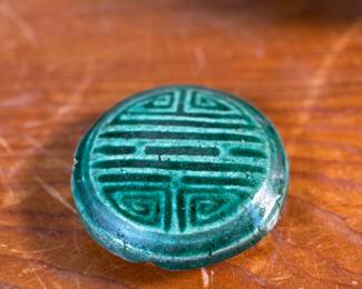 This lot features an antique Chinese green-glazed pottery ginger jar. Originally used for storing spices and herbs, the tradition of ginger jars dates back to China’s Qin dynasty. This jar measures, 4.5” H x 5.5” W x 5.5” D.