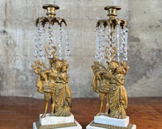 This lot features a pair of high quality Victorian polished brass candelabras with prisms and marble bases. Each one measures, 15.5” H x 5.5” W x 3.5” D.