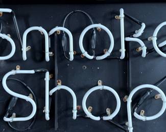“Smoke Shop”, a vintage neon sign that measures, 20” H x 31” W. This sign appears to be in good overall condition, but is missing the plug to test.