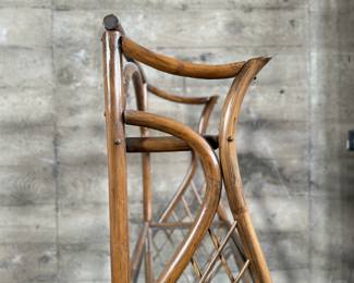 This lot features a vintage rattan shelving unit with two glass shelves on the top two tiers. This unit measures, 71.5” H x 29.5” W x 19.5” D.