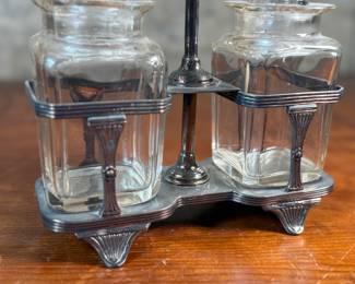 This lot features an antique silver-plated and crystal double pickle castor set, manufactured by Walker & Hall. Maker marks present underneath as shown in photos. Both inserts have minor chipping around the lid. This set measures, 10.25” H x 7.5” W x 4” D.