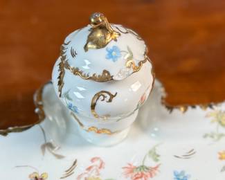 This lot features a collection of inkwells and accessories. One appears to be handmade out of wood and signed underneath by John R Craighead.