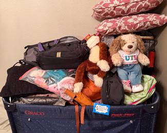 Assortment of decorative pillows and stuffed animals