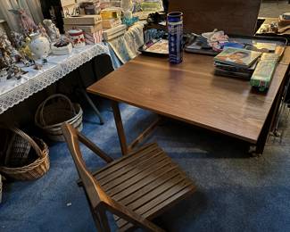 A very cool mid-century, modern table and chairs set. The table folds down, and the chairs are stored inside the table.