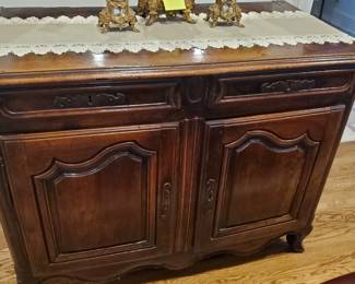 This buffet has a two-door opening and would fit anywhere, breakfast room, dining room, or living room.