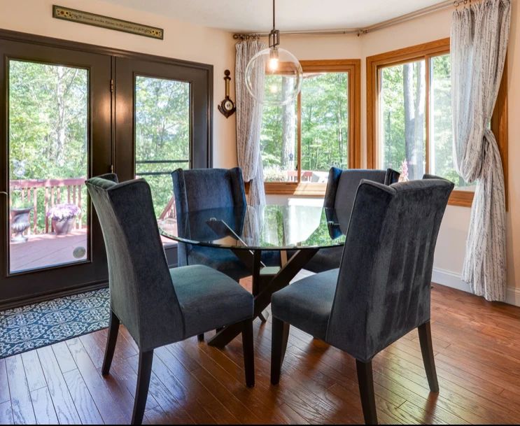 Elegant,comfortable dining glass round table with custom blue velour parsons chairs
