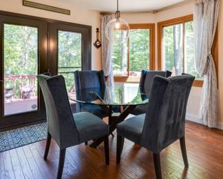 Elegant,comfortable dining glass round table with custom blue velour parsons chairs