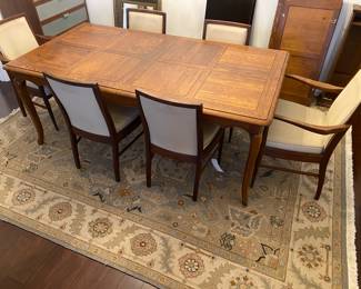 Solid Wood Dining Table with 2 leaves and custom protective cover. 6 Alfred Cox of England Dining Chairs.