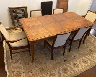 Solid Wood Dining Table with 2 leaves and custom protective cover. 6 Alfred Cox of England Dining Chairs.