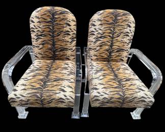 Vintage lucite pair of chairs on casters with zebra fabric