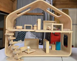 Wooden contemporary style dollhouse by Plan Toys, with furniture.  Brand new and unused. 