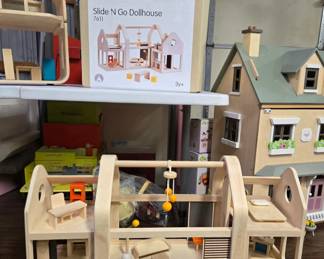 Wooden dollhouse by Plan Toys, in a unique mid-century modern style, complete with furniture. Brand new and unused with box. 