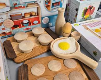 Wooden kitchen toys including a muffin pan, cookie tray, milk bottle, egg cup, and felt egg, handmade by a Michigan toymaker. All new. 