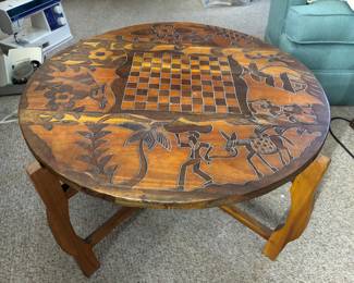 Reversible vintage hand carved table bought overseas many years ago in Haiti. Homeowner picked it up while cruising on boat. People were selling stuff on smaller boats below, and they would haul things up like loot.