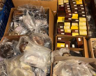 Doll wigs, boxes of shoes and clothing and doll parts