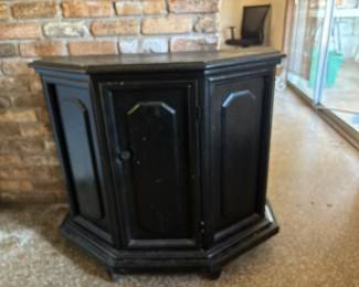 Half-octagonal corner storage cabinet.