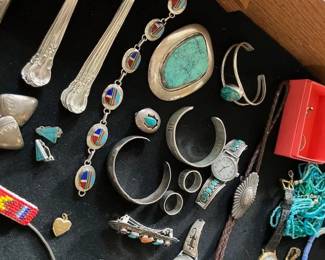 Sterling flatware, Native American jewelry including bollo by Auturo Rivera and Marilyn Luana.  
