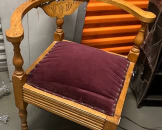 Late 19th–early 20th century oak corner chair (roundabout chair) with small casters
