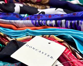 Baskets loaded with silk scarves. Many new with tags. 