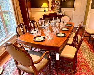 Many elegant items in the dining room!  ($1500 Beautiful dark wood dining table with carved detail and inlay- 3 additional leaves not shown- 89 x 44 x 30.5), ($240 wood and leather side armed dining chair with nailhead trim- 2 available- 26 x 25 x 39.5), ($200 dark wood dining chair with carved wood detail and nailhead trim- 8 available- 21 x 19 x 28), ($320- set of 8- Bavaria Waldershof 22K gold china dinner plates- minor coppering around rims), ($240- set of 8- Waterford Kylemore water goblets), ($200- set of 8-Waterford Kylemore claret wine), ($200- set of 8- Waterford Kylemore flat tumbler), ($500- set of 8- Waterford double old fashioned- great size!), ($48 each- silver-plate candleabra- 2 available)