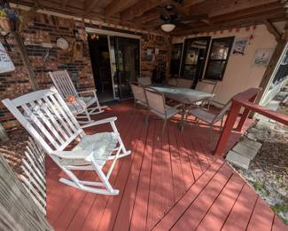 Backyard patio - white wooden rocking chairs, outdoor furniture and decor