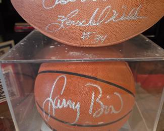 Lots of signed basketballs and footballs 